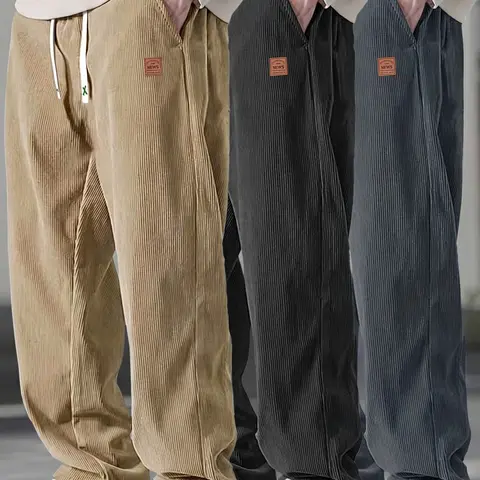 Men’s relaxed-fit black corduroy casual pants — lightweight for summer with a drapey feel, leather tag detail, drawstring elastic waistband; suitable for work and everyday wear.