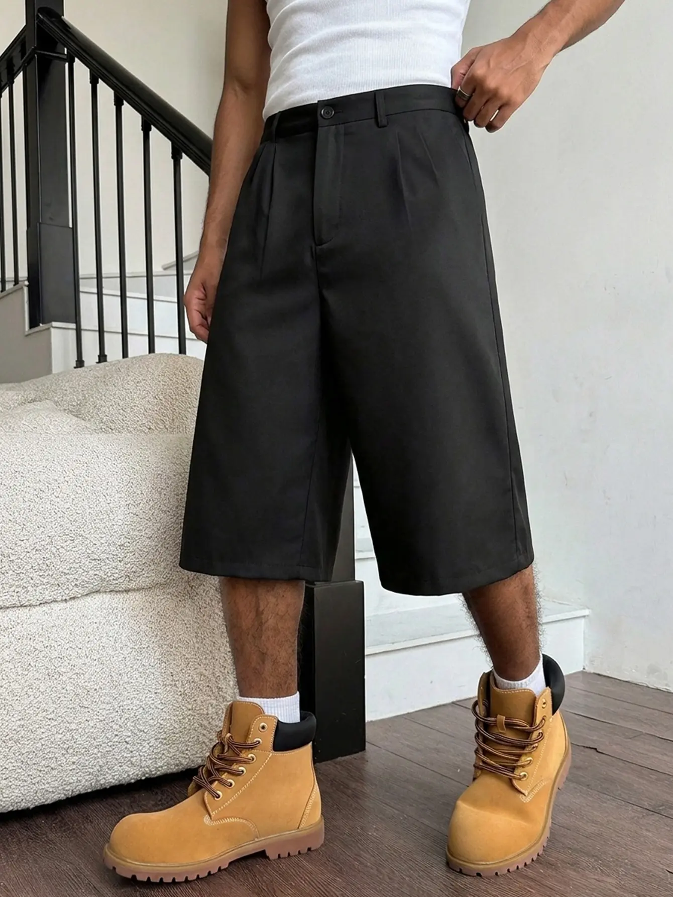 Men’s black pleated wide-leg suit shorts with a button front, high waist, loose culotte fit, wrinkle-resistant wear-resistant fabric, suitable for streetwear, light business casual, urban style, and summer looks.