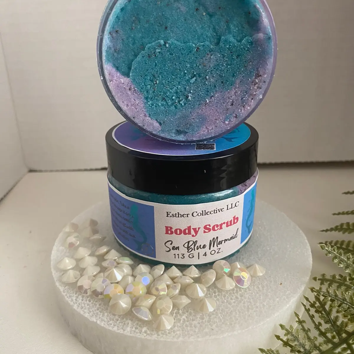 Sea Blue Mermaid scrub is a delightful exfoliating body scrub that captures the essence of the ocean and adds a touch of whimsy to your skincare routine. Here's a description of this scrub and its potential benefits:  1. Ocean-inspired Exfoliation: Sea